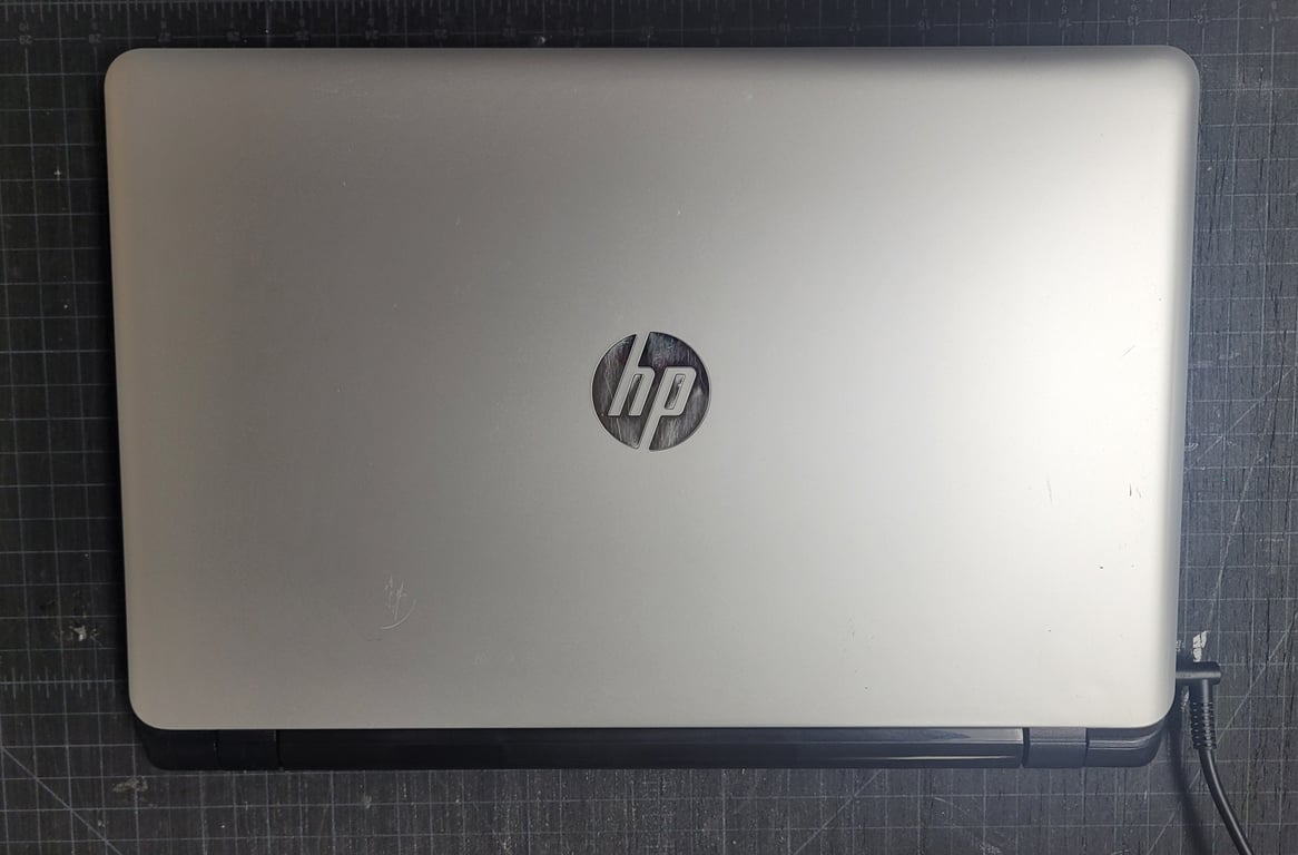 Silver HP 355 G2 refurbished laptop shown closed from above with light cosmetic wear on the lid.
