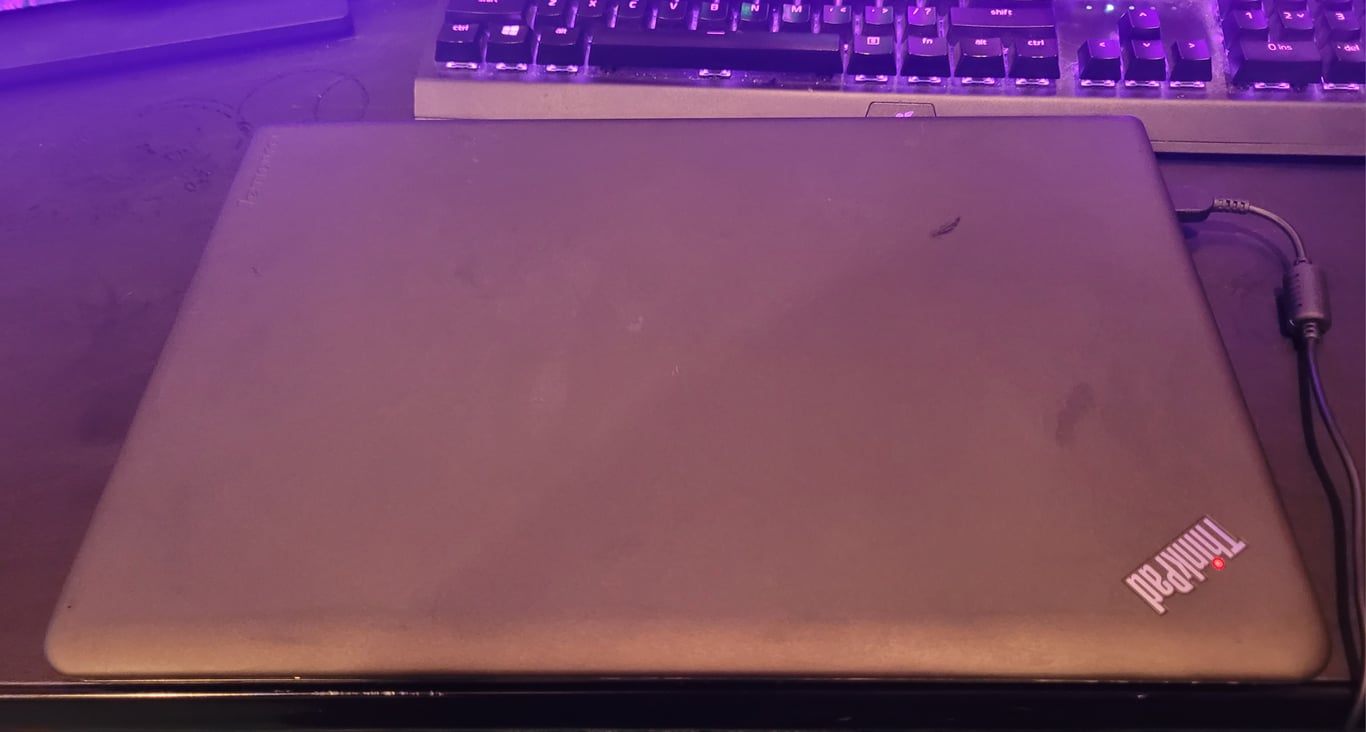 Closed Lenovo ThinkPad E560 lid showing normal cosmetic wear