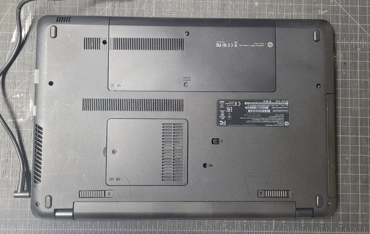 Bottom view of an HP 355 G2 refurbished laptop showing the underside, ventilation openings, access panels, and HP identification label.