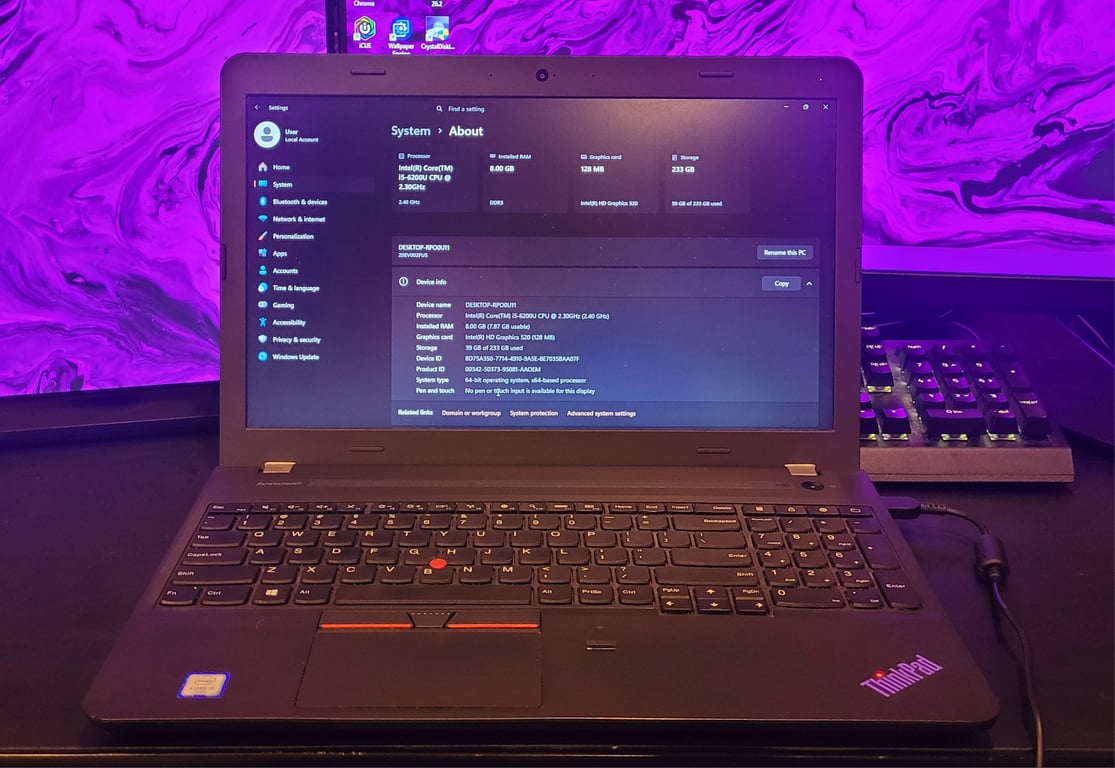 Lenovo ThinkPad E560 open with Windows 11 system information displayed